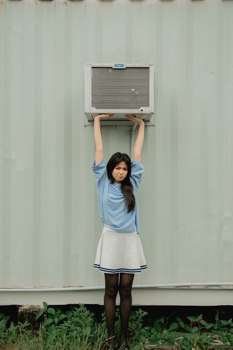 Brunette Girl Wearing Skirt Stretching Arms And Pushing A Ventilator