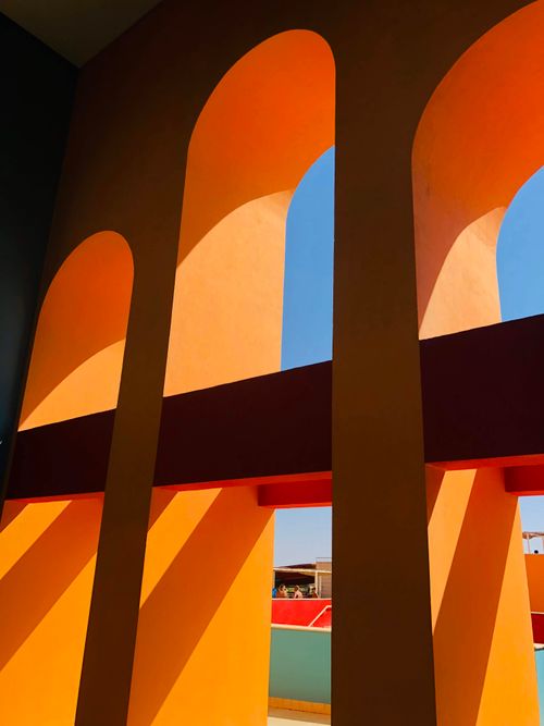 Free Colorful arches creating shadows in Hurghada, Egypt. Bright and dynamic urban architecture. Stock Photo