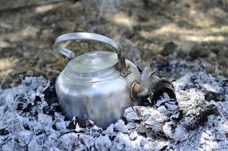 A Kettle Pot On Burning Charcoal