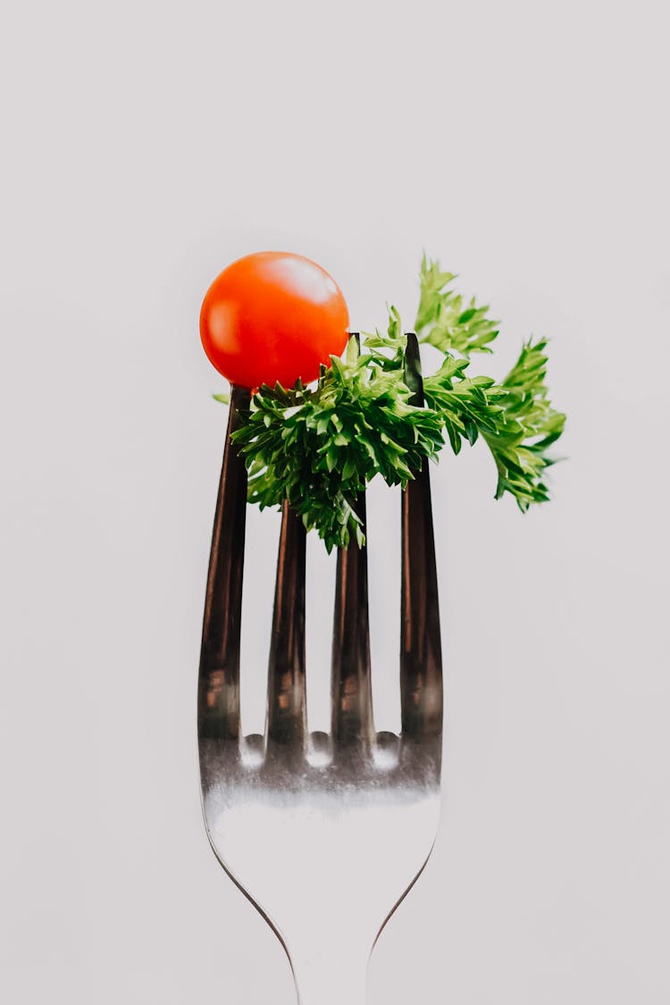 Tomato And Leaves On Fork