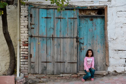 Little Girl Sitting on a Doorstep
