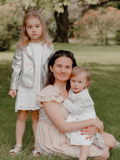 Free A mother with her two young daughters enjoying a peaceful day in the park. Stock Photo