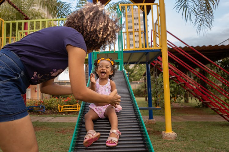 A Woman At The Playground With Her Kid