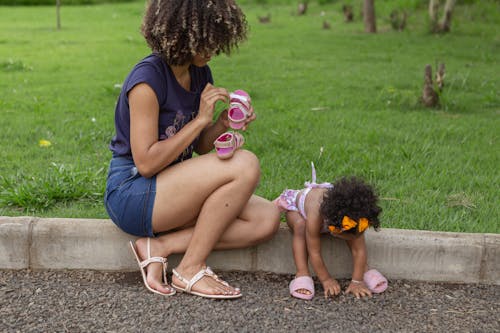 Mother and Daughter Sitting on the Gutter