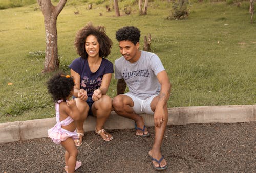 Free Couple with Their Child Playing at the Park Stock Photo