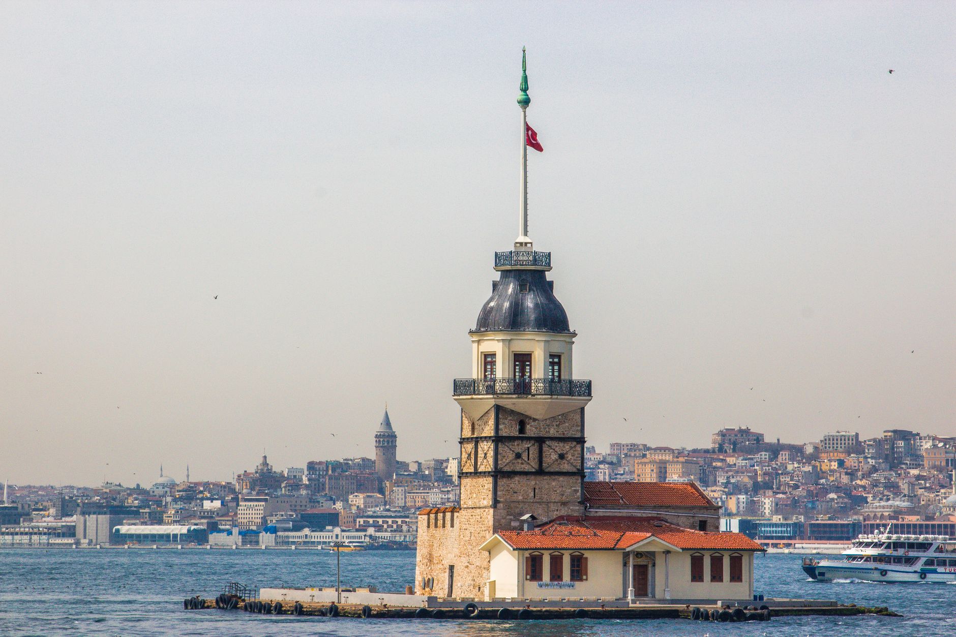 The iconic Maiden's Tower on the Bosphorus with Istanbul skyline in the background.