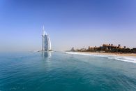Iconic Burj Al Arab overlooking the pristine Dubai beach, perfect for travel and leisure.