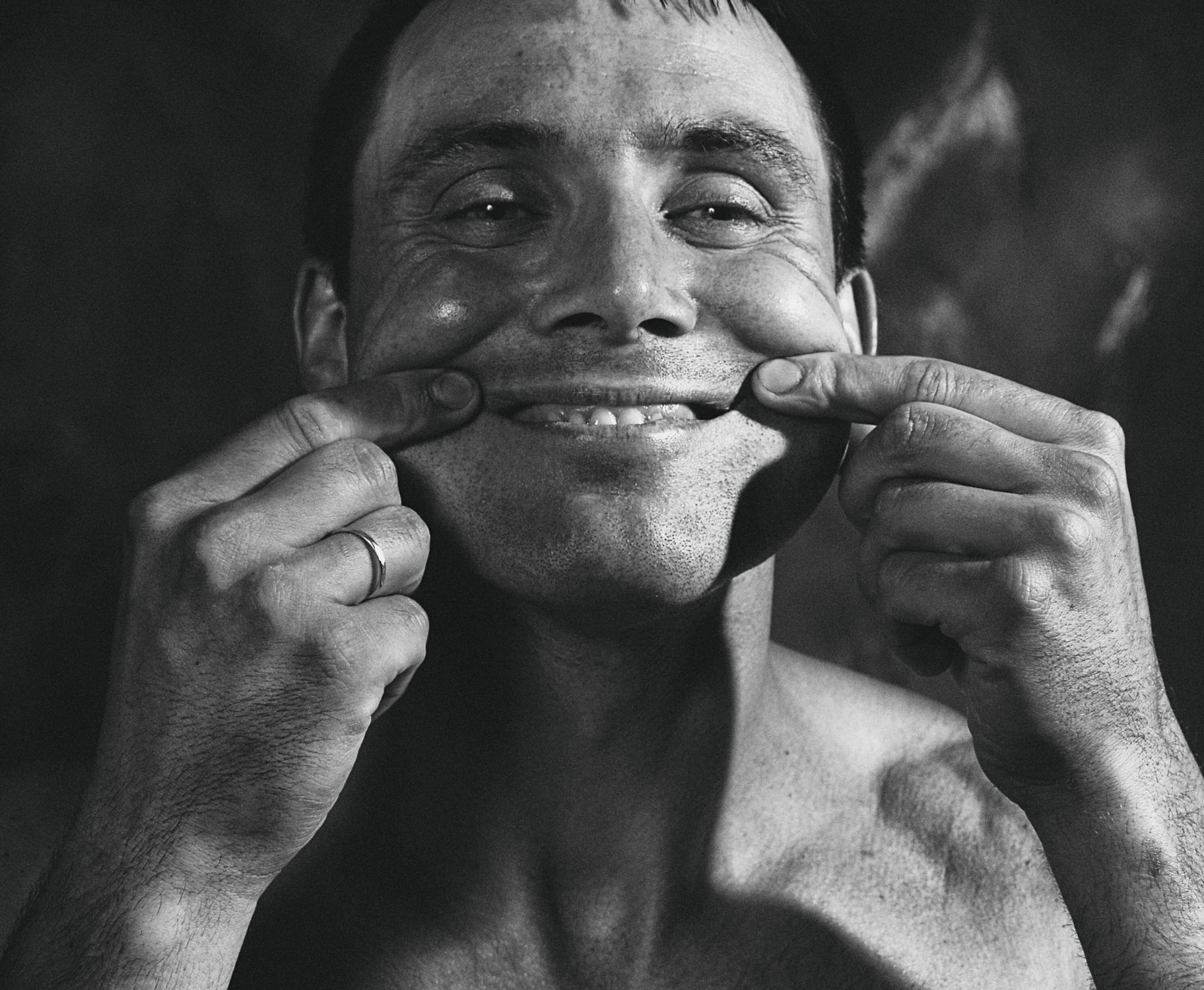Monochrome Photo of a Man Pinching His Cheeks · Free Stock Photo