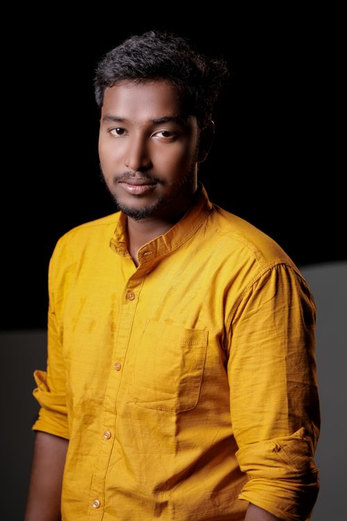 Free Studio portrait of a man in a yellow shirt with facial hair, showcasing casual style. Stock Photo