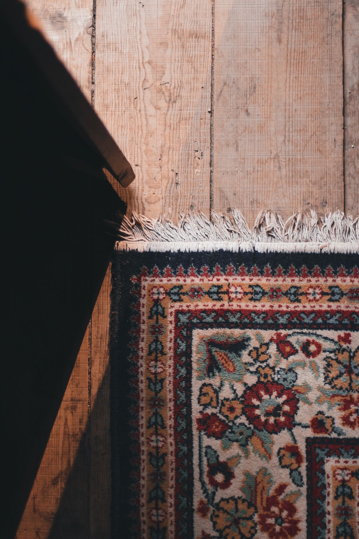 Close-up of a rug corner with fringe