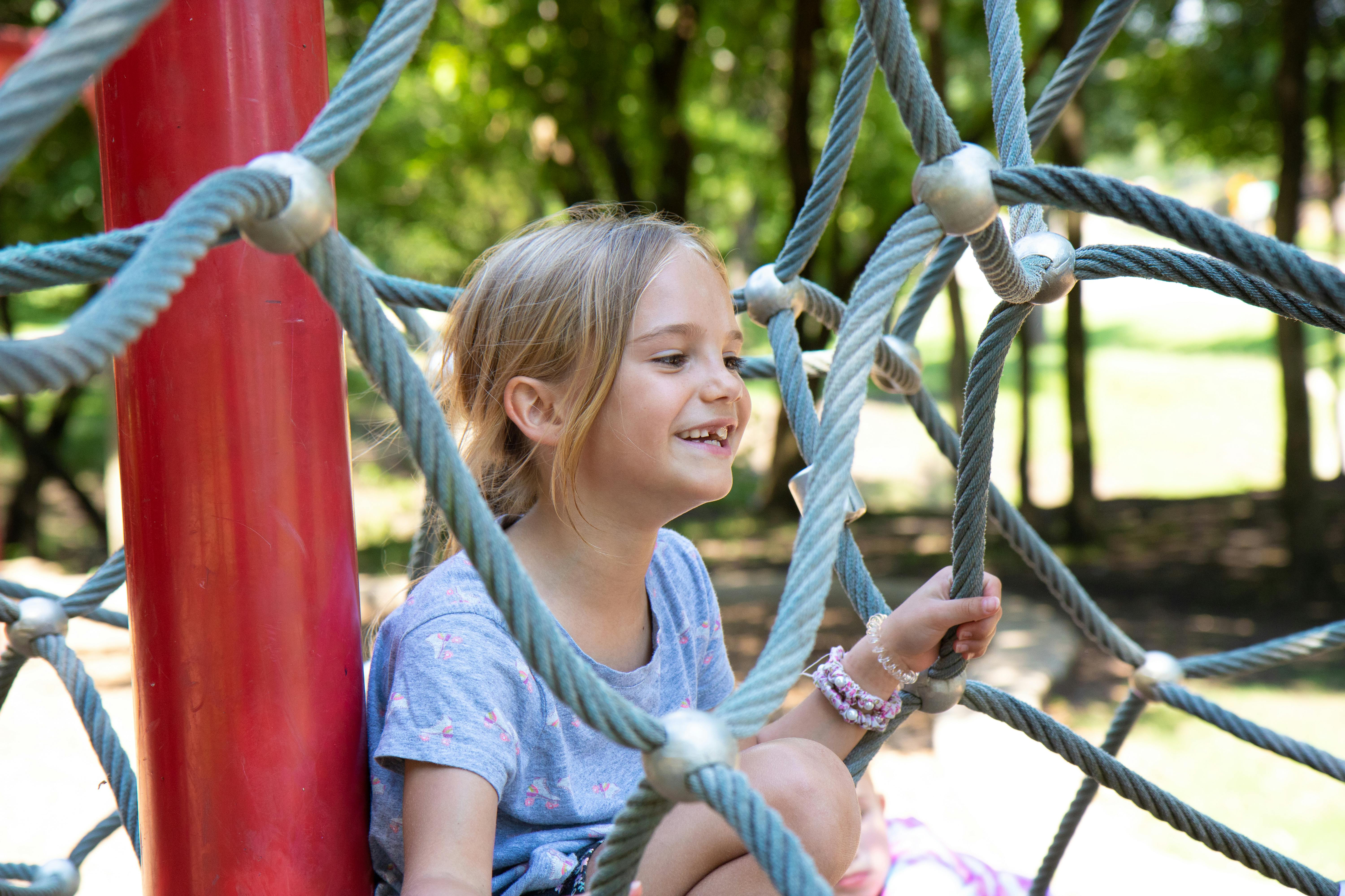 child playing outdoors in a park - frequent eye rubbing