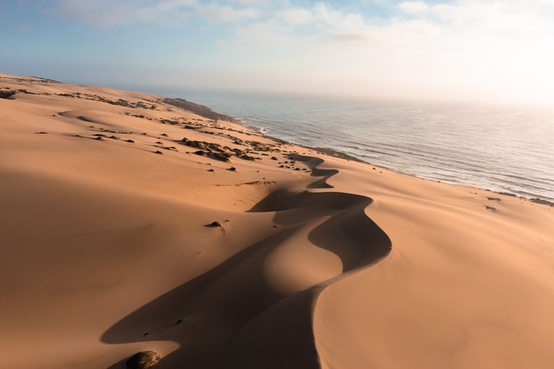 Large sand dunes meeting the ocean coast — the dramatic landscape of Japan's only large dune system at the Sea of Japan shore