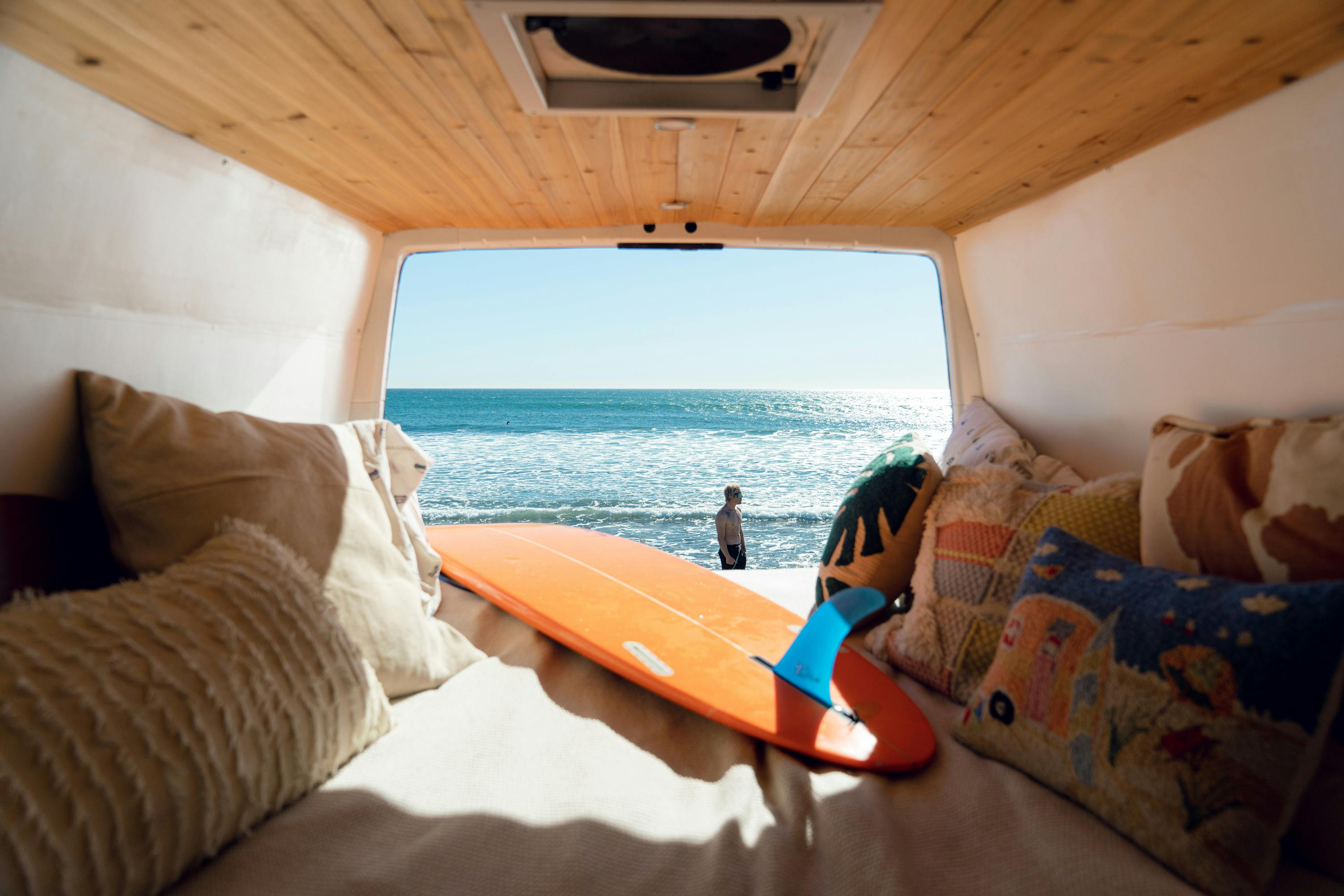 Happy friends on camper van roof · Free Stock Photo