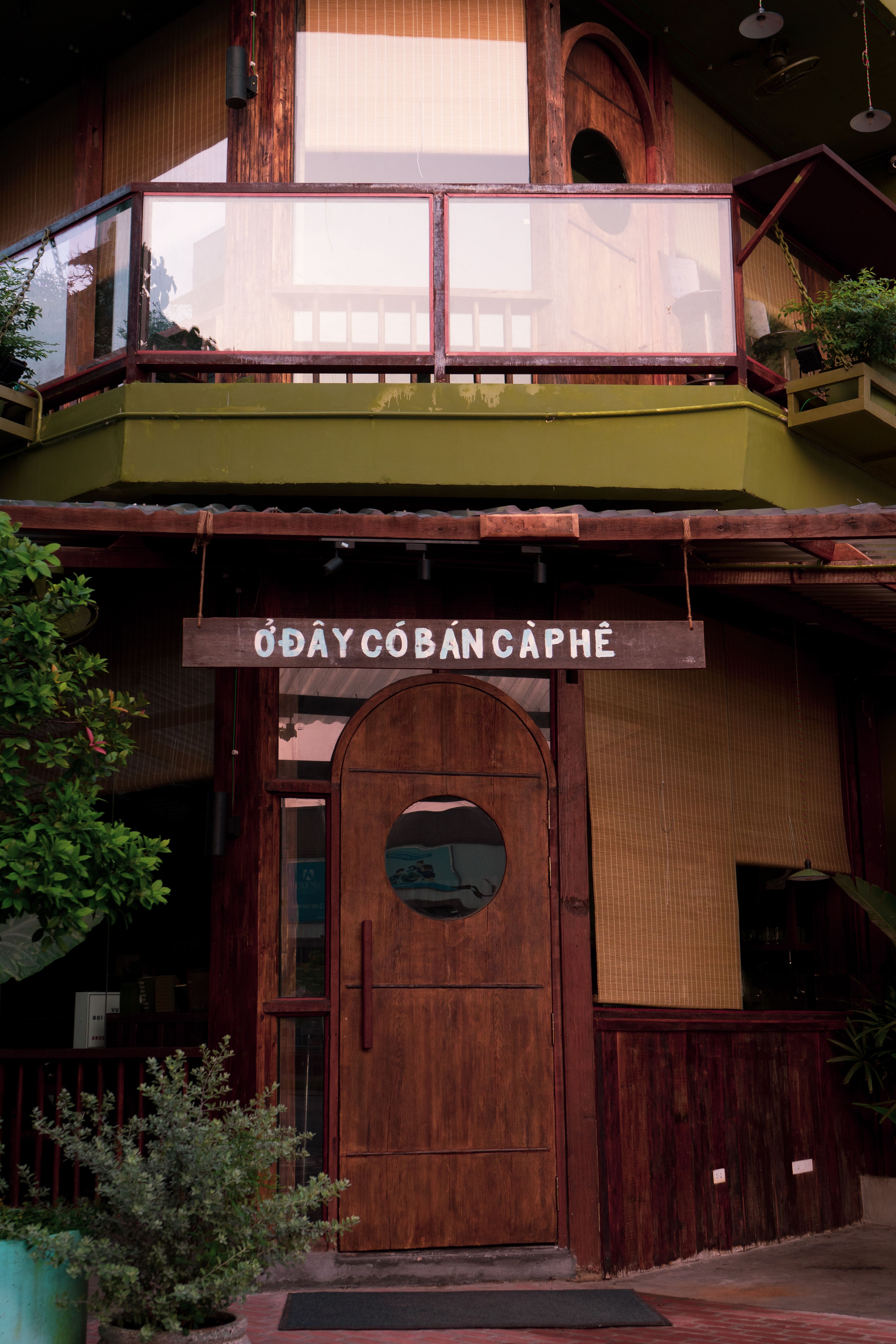 Charming wooden facade of a Vietnamese coffee shop with traditional design and warm atmosphere.