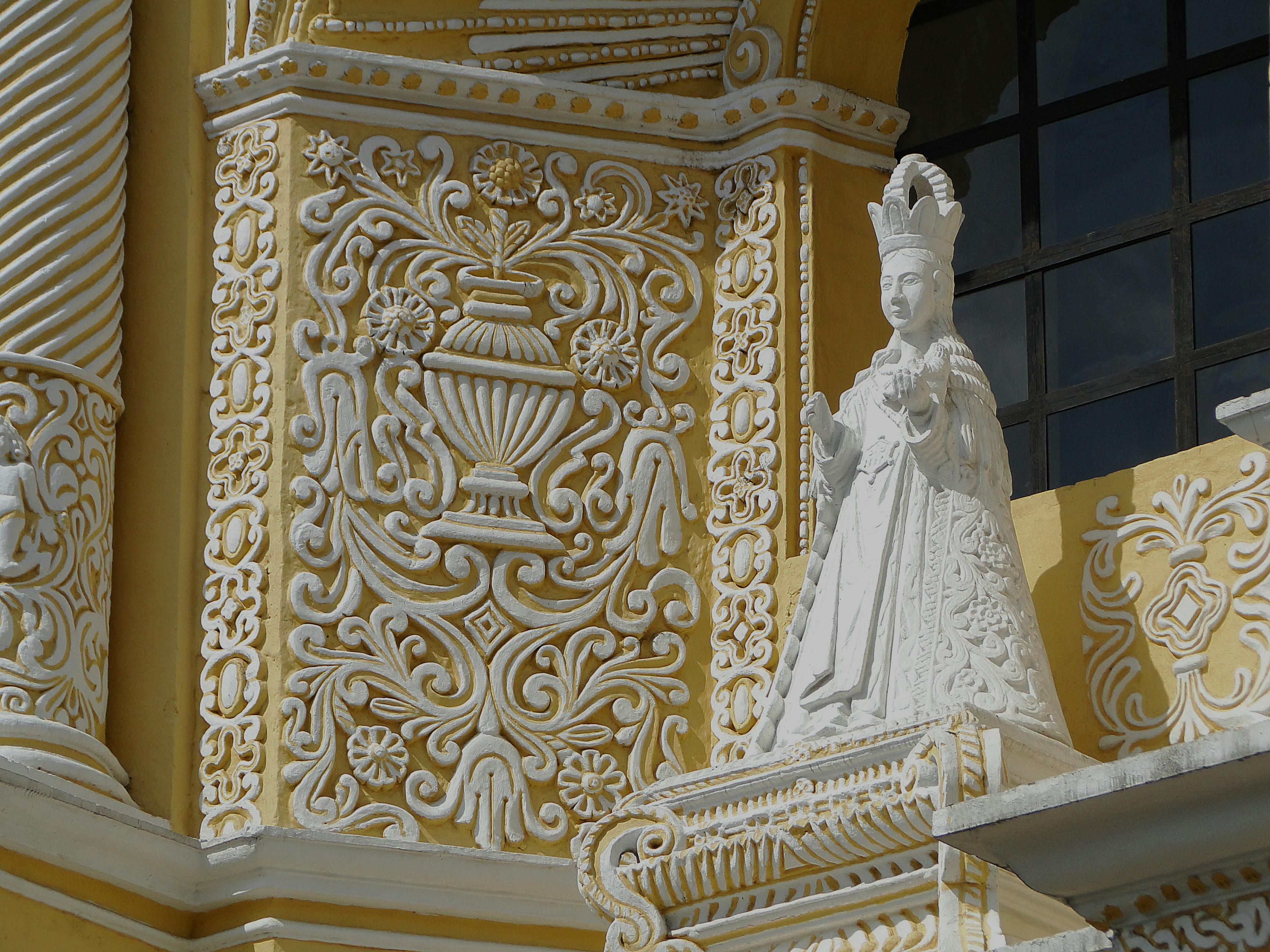 a white religious statue at la merced church in guatamela