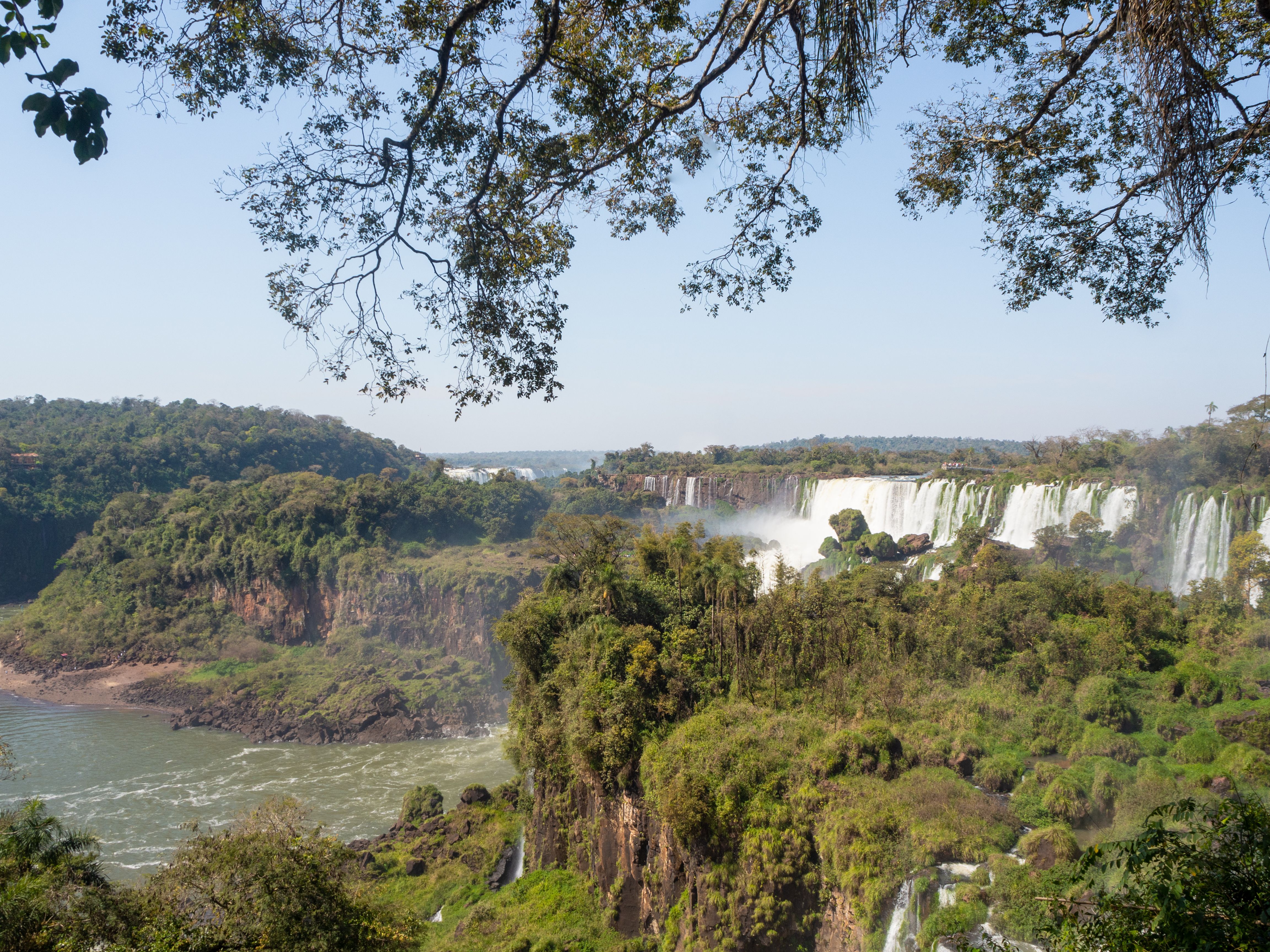 Tourists on a boat getting drenched under Iguazu Falls in Argentina