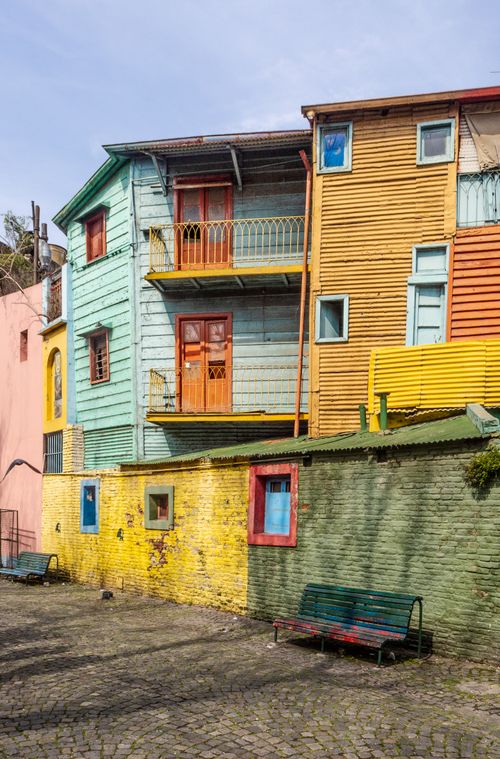 Free Vibrant wooden houses in a picturesque residential area with multi-colored facades. Stock Photo