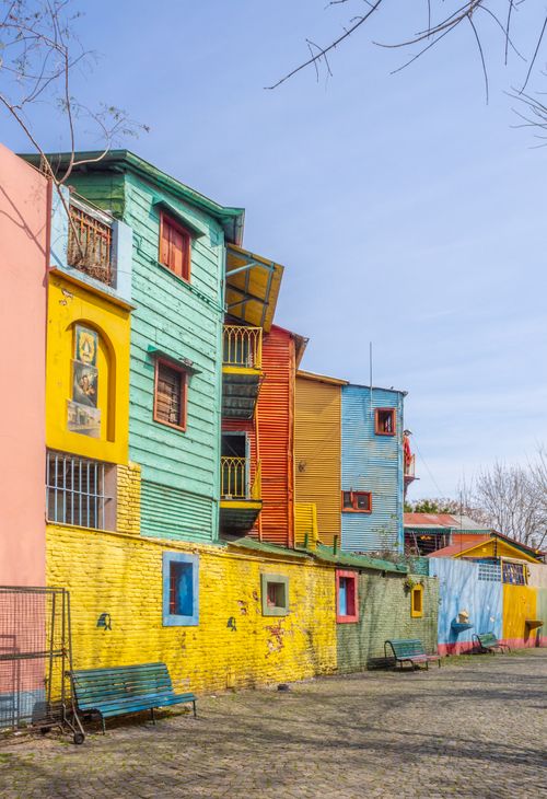 Free Vibrant, colorful houses line a sunny street in La Boca, Buenos Aires. Stock Photo