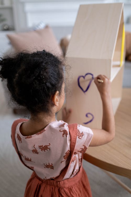 A Girl Painting a Dollhouse 