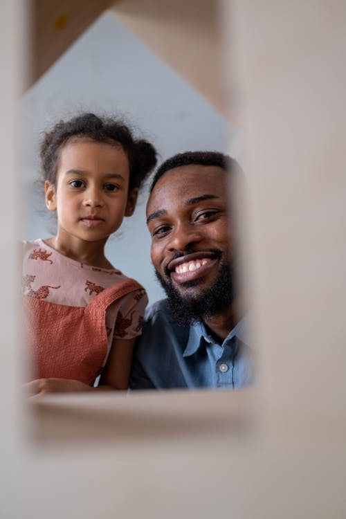 A Man and a Young Girl Smiling