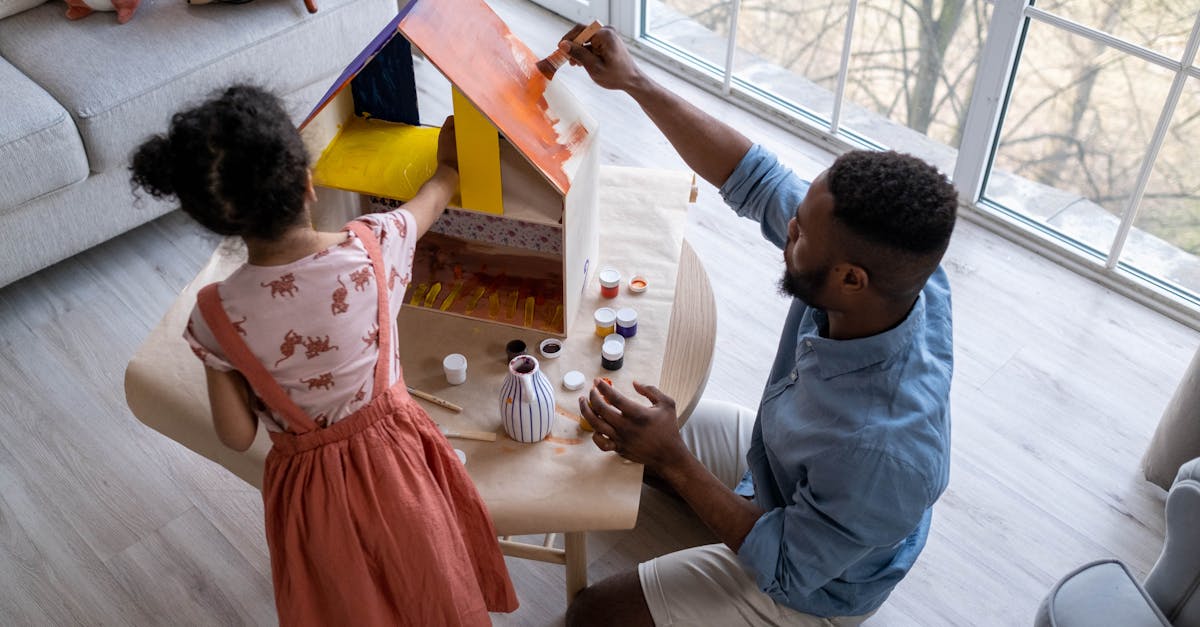 Parent And Child Engaging In Separate Hobbies Or Activities