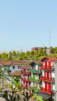 Vivid Basque-style buildings with colorful balconies in Hondarribia, showcasing traditional architecture on a sunny day.