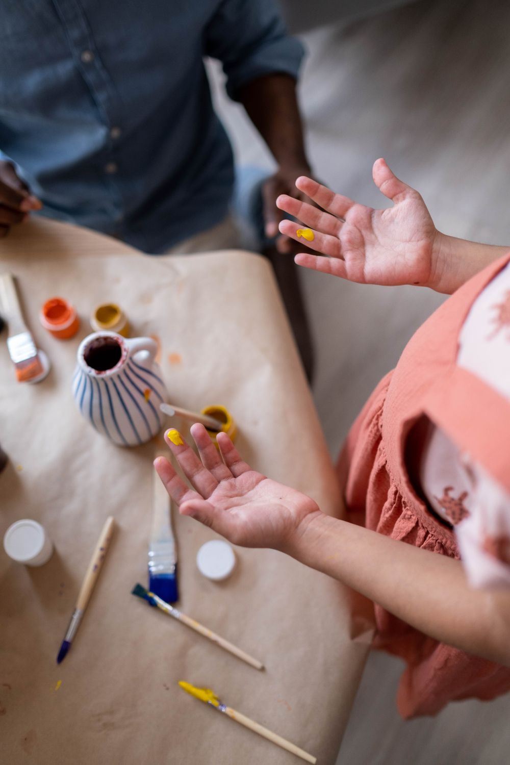 Painted hands during a colorful art project