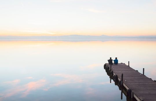People Sitting on Wooden Dock