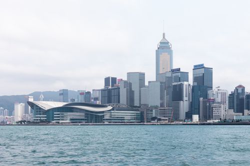 Free Scenic view of Hong Kong skyline with iconic skyscrapers and waterfront harbor. Stock Photo