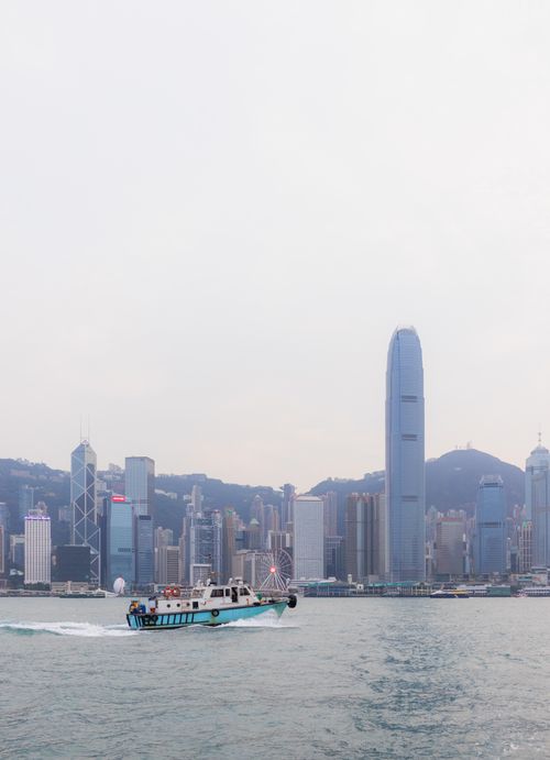 Free Elevated view of Hong Kong skyline featuring a ferry and harbor, showcasing iconic skyscrapers. Stock Photo