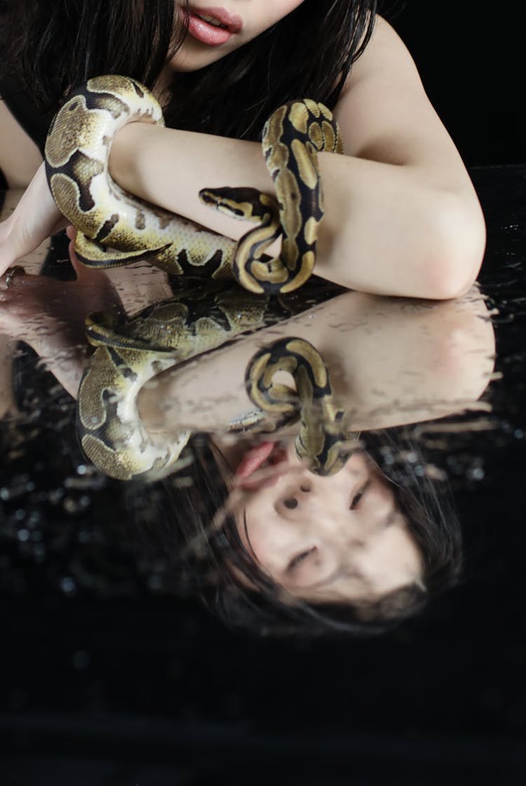 Close Up Shot Of A Woman With Snake 