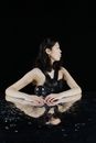 Woman in Black Tank Top Lying on Water