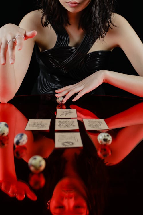 Free Woman Looking at Tarot Cards on Glass Table Stock Photo