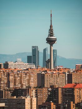 A breathtaking view of Madrid's skyline with Torrespaña television tower and modern skyscrapers.
