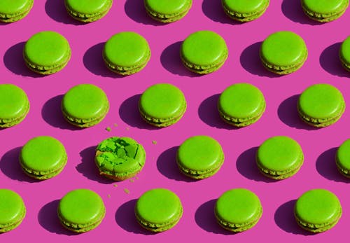 Pattern of Green Macaroon Cakes on Pink Background