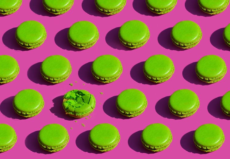 Pattern Of Green Macaroon Cakes On Pink Background