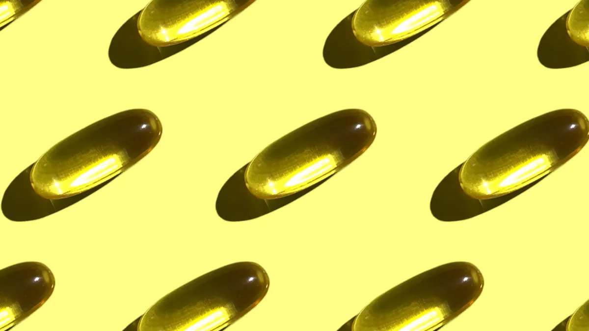 Supplement bottles, capsules and tablets on a plain surface