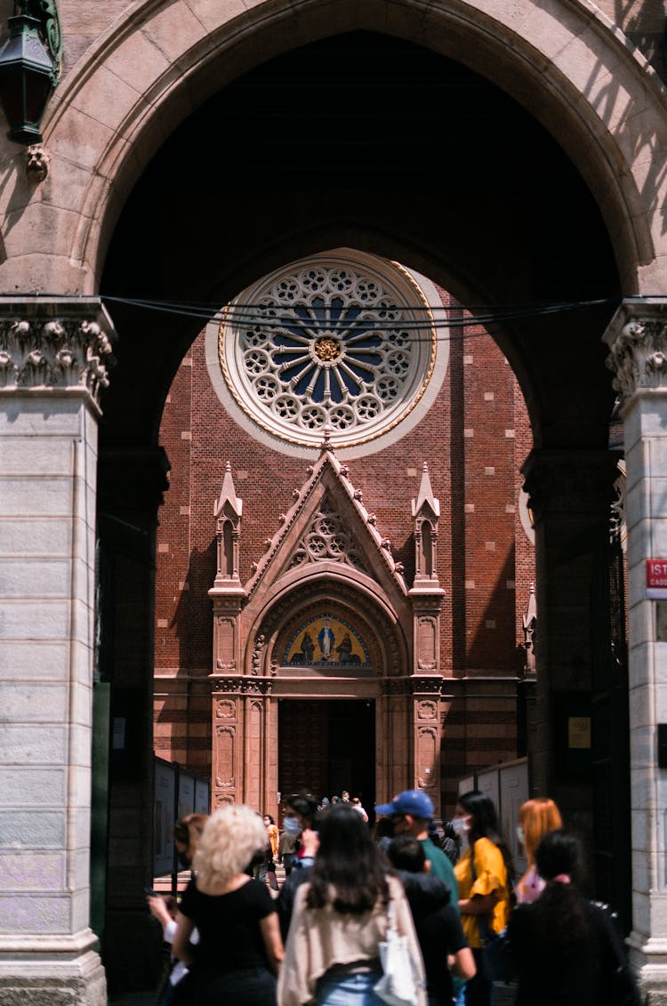 People Standing Outside A Church Building