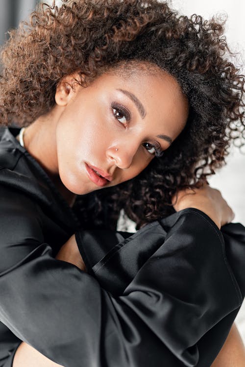 Woman with Curly Hair Wearing Black Top