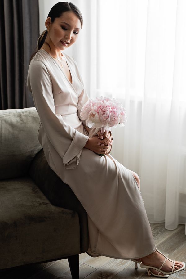 Woman wearing a champagne silk wrap dress
