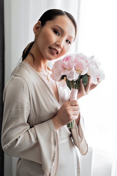 Pretty Woman Holding pink Flowers