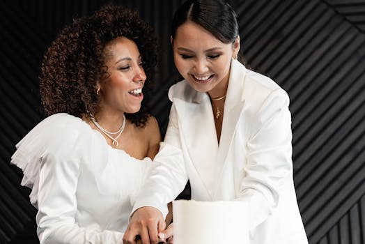 Happy lesbian couple slicing wedding cake together, celebrating love and commitment.