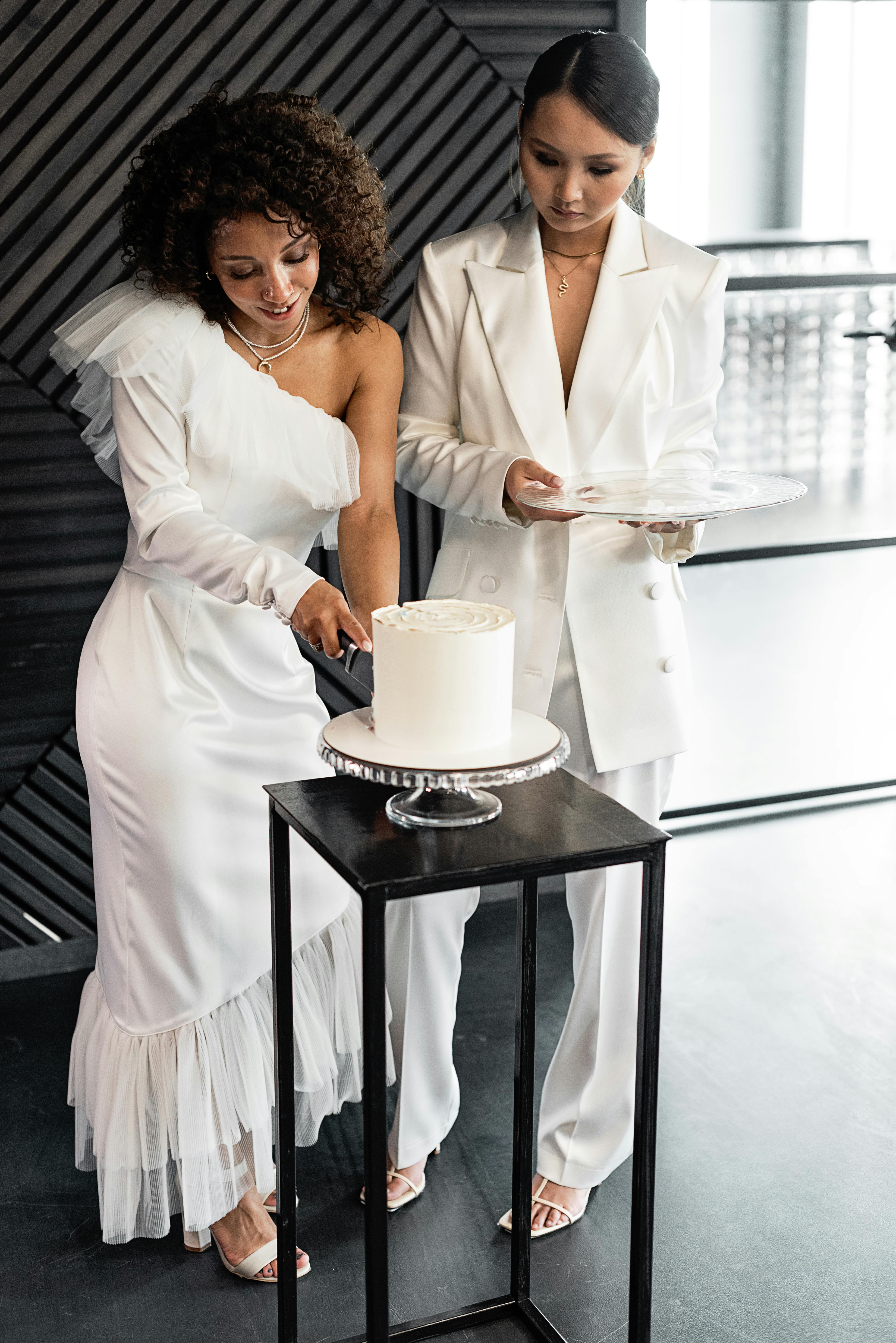 a bride cutting a wedding cake