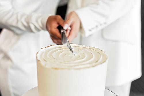 A Knife Slicing Through a Wedding Cake