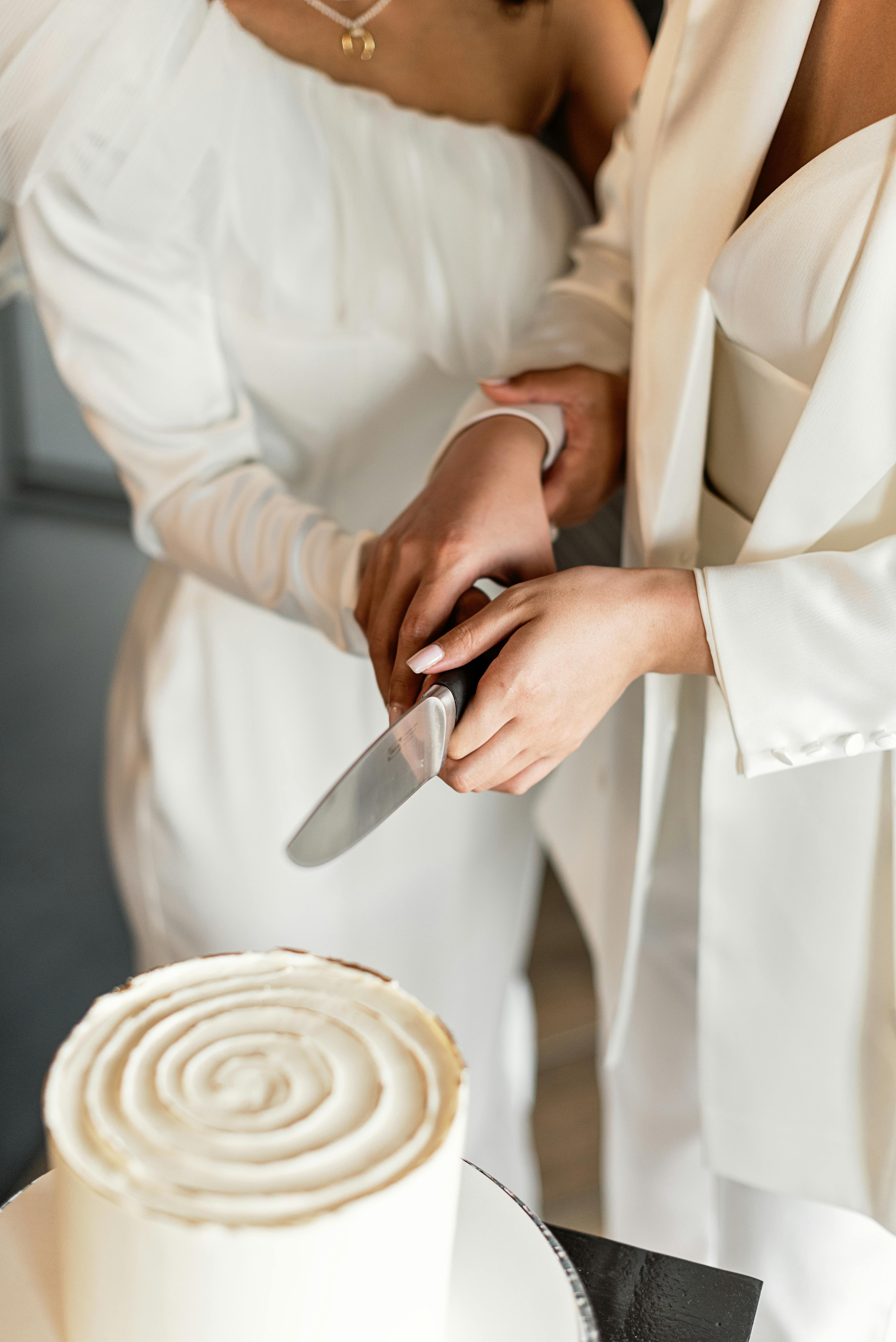 a people slicing a cake