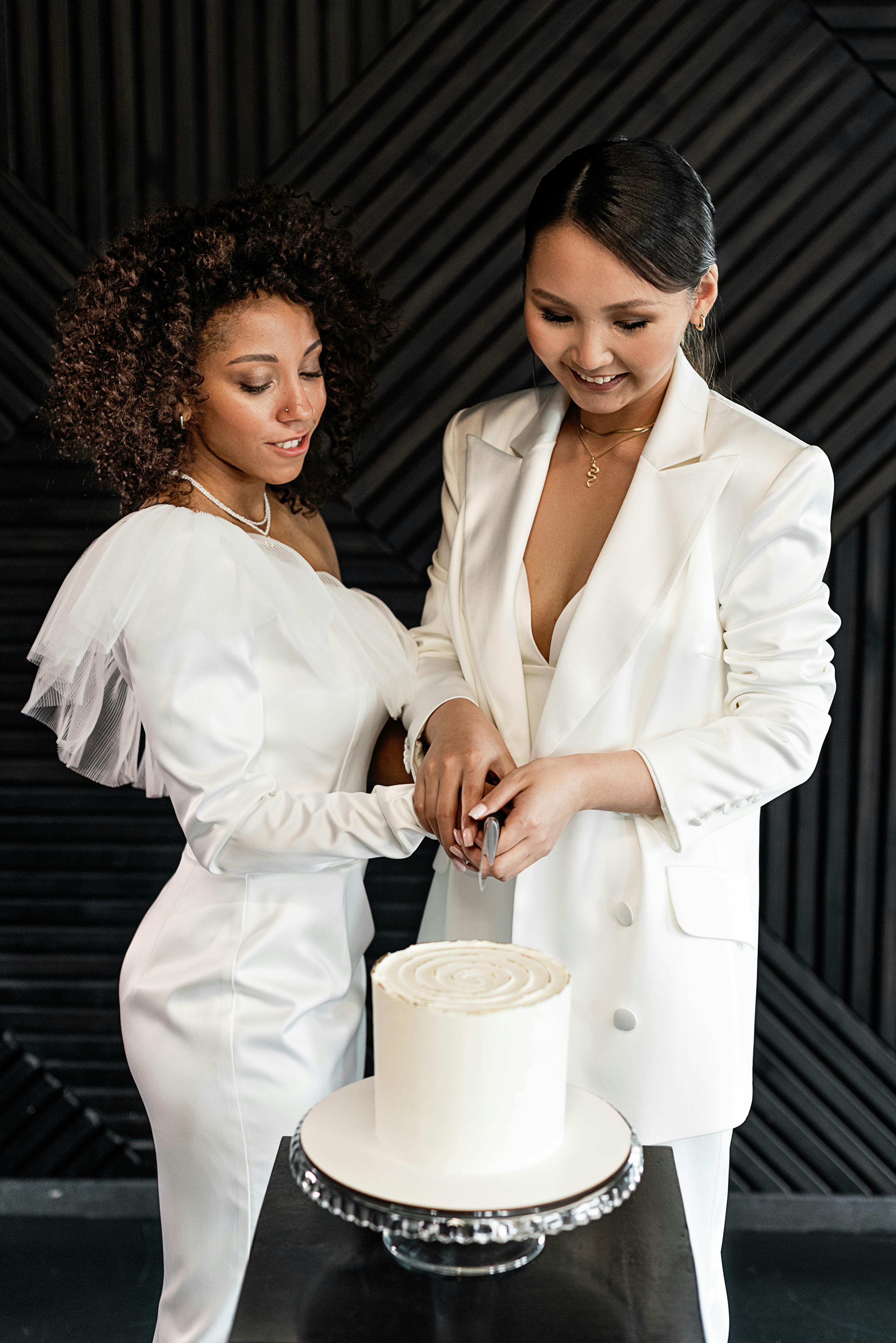 a happy newlywed couple cutting a wedding cake together