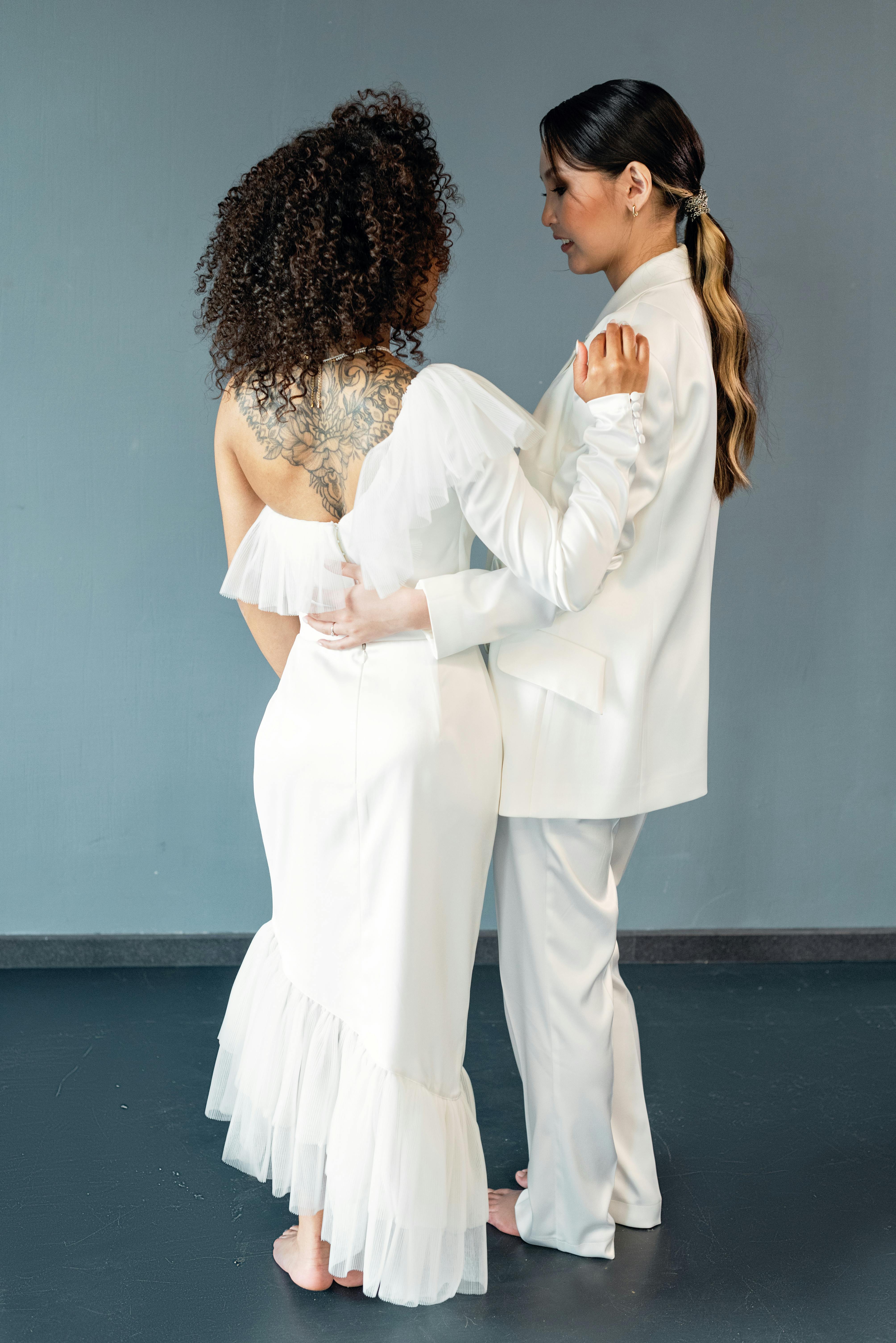 brides in wedding clothes and barefoot