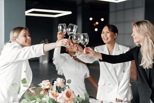 Women Clinking Wine Glasses