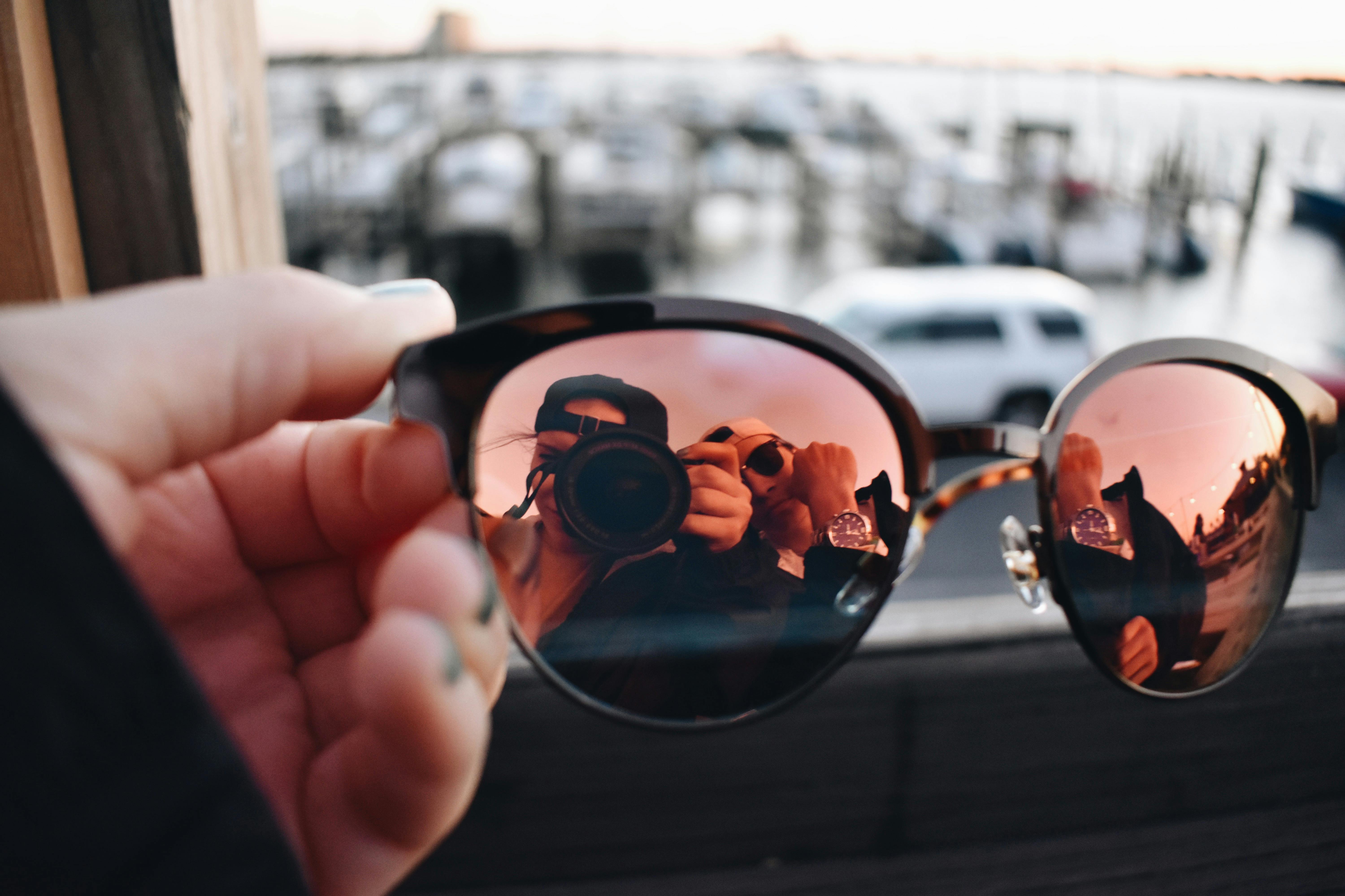 Reflection of Palm Trees in Aviator Sunglasses · Free Stock Photo