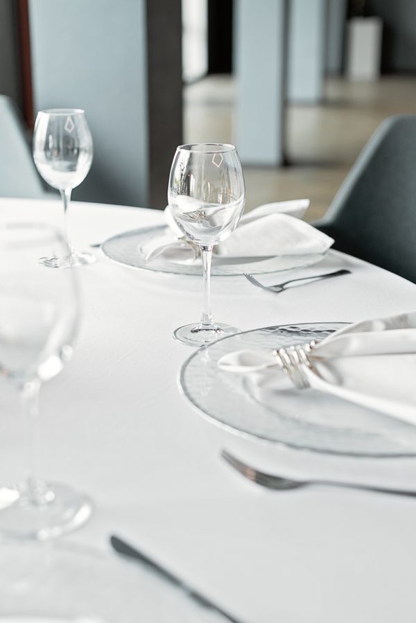 Elegant table setting with wine glasses and folded linens